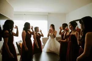 Friends crowded together for a phone photo at the reception