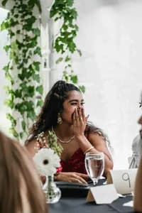 A guest laughing at her table during the reception