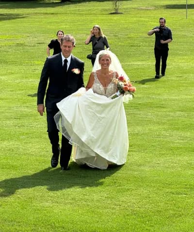 The couple crossing the lawn after the ceremony, caught on a guest's phone