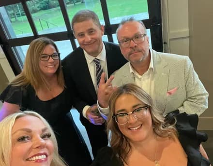 Guests crowding in for a selfie at the reception